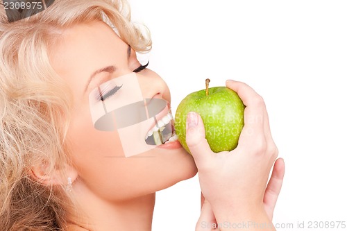 Image of young beautiful woman with green apple
