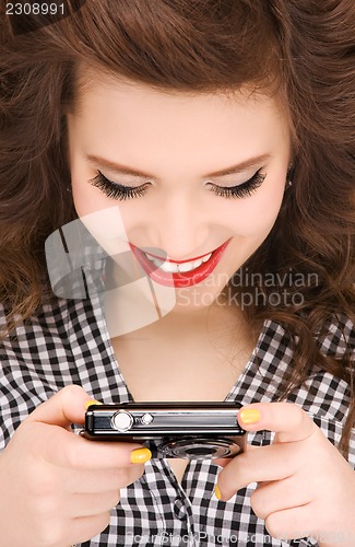 Image of happy teenage girl with digital camera