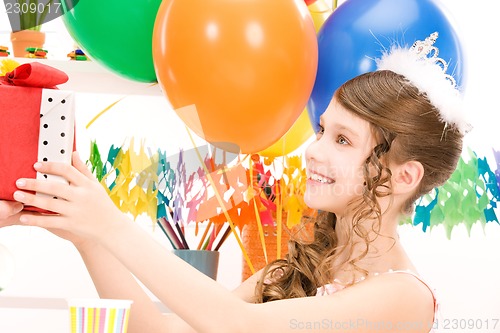 Image of party girl with balloons and gift box