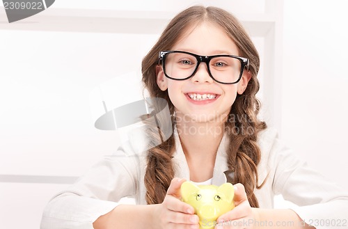 Image of little girl with piggy bank