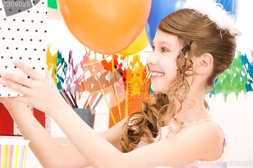 Image of party girl with balloons and gift box