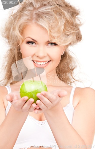 Image of young beautiful woman with green apple