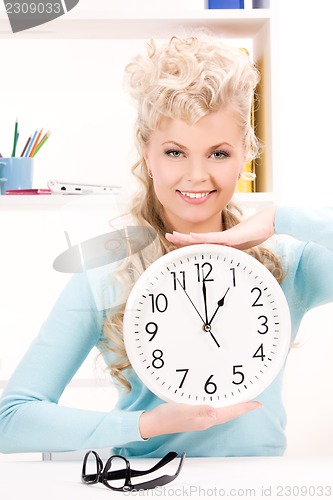 Image of woman holding big clock