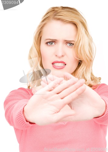 Image of young woman making stop gesture