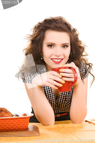 Image of young attractive woman in the kitchen