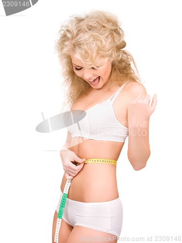 Image of young beautiful woman with measure tape