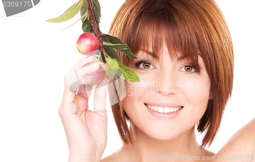 Image of happy woman with apple twig
