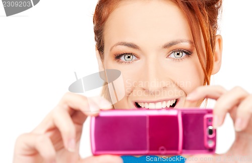 Image of happy woman using phone camera