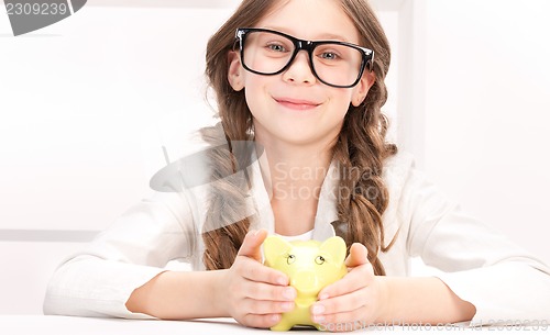 Image of little girl with piggy bank