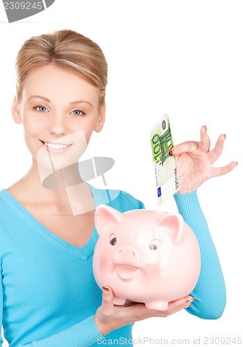 Image of lovely woman with piggy bank and money