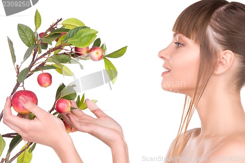 Image of lovely woman with apple twig