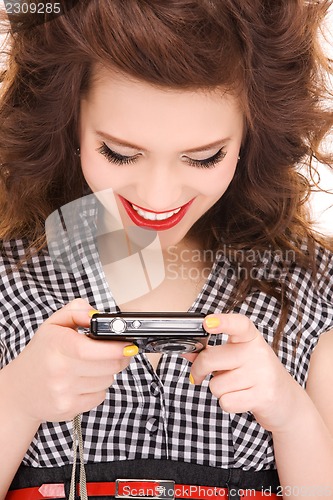 Image of happy teenage girl with digital camera