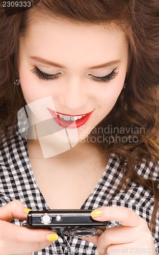 Image of happy teenage girl with digital camera