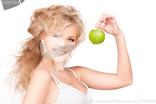 Image of young beautiful woman with green apple