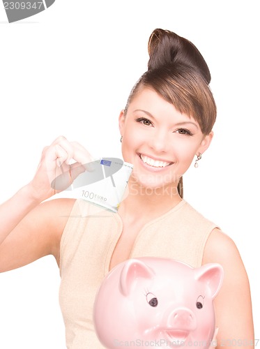Image of lovely woman with piggy bank and money