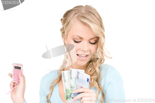 Image of happy woman with calculator and money