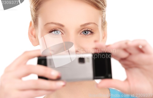 Image of happy woman using phone camera