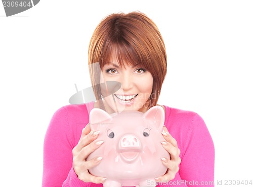 Image of lovely woman with piggy bank  