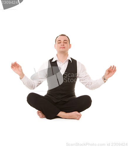 Image of businessman sitting in lotus pose