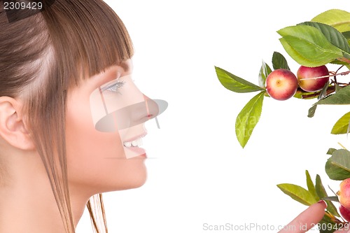 Image of lovely woman with apple twig