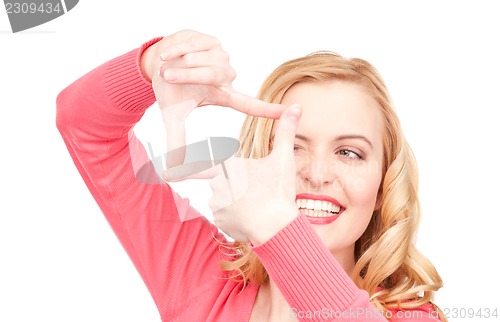 Image of lovely woman creating a frame with fingers