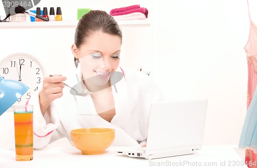 Image of eating woman laptop computer