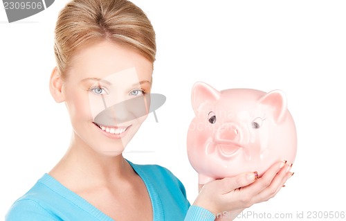 Image of lovely woman with piggy bank