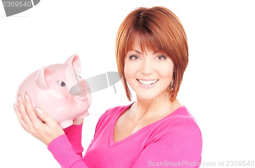 Image of lovely woman with piggy bank  