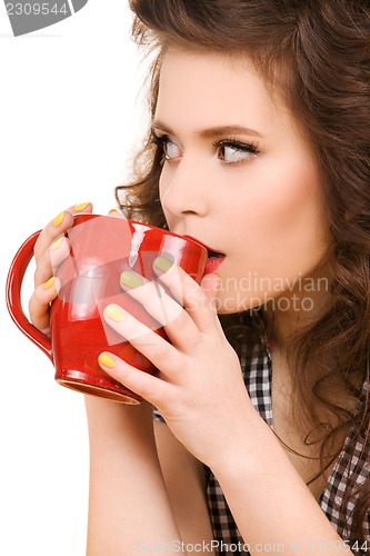 Image of young attractive woman in the kitchen