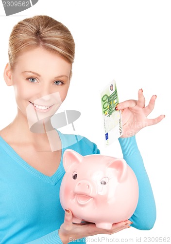 Image of lovely woman with piggy bank and money