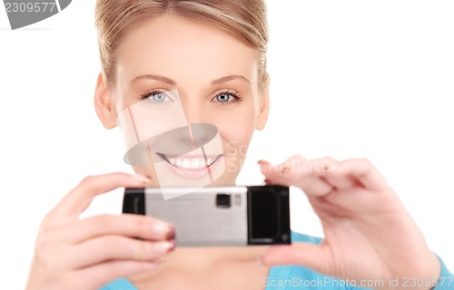 Image of happy woman using phone camera