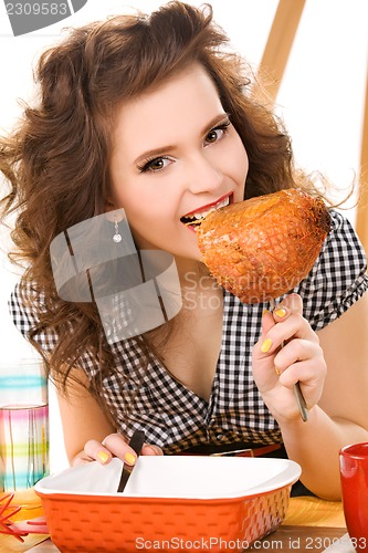 Image of young attractive woman in the kitchen