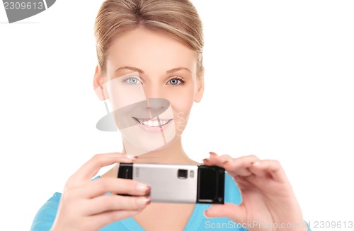 Image of happy woman using phone camera