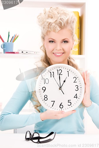 Image of woman holding big clock