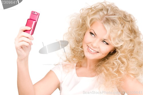 Image of happy woman using phone camera