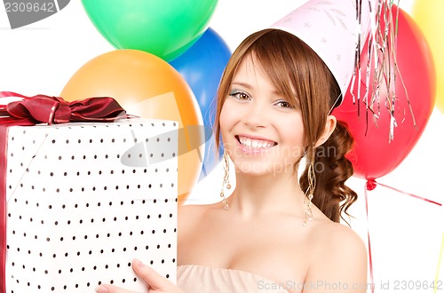Image of party girl with balloons and gift box