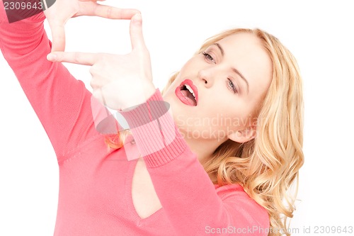 Image of lovely woman creating a frame with fingers              
