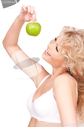 Image of young beautiful woman with green apple
