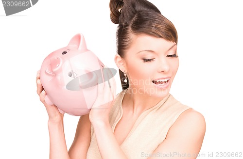 Image of lovely woman with piggy bank