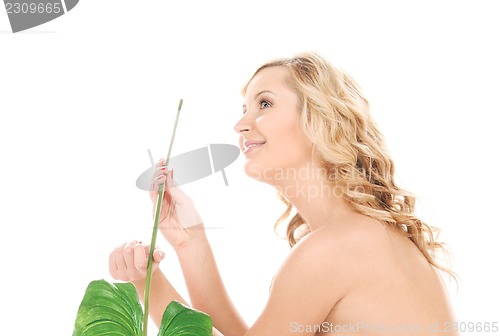 Image of woman with green leaf