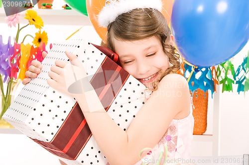 Image of party girl with balloons and gift box