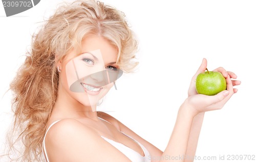 Image of young beautiful woman with green apple