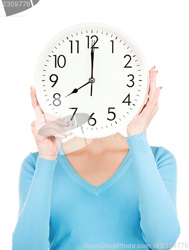 Image of woman with big clock covering face