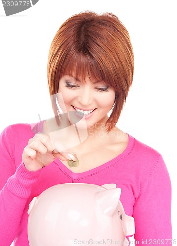Image of lovely woman with piggy bank and money