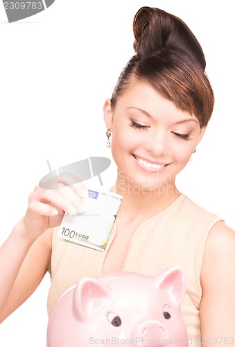 Image of lovely woman with piggy bank and money