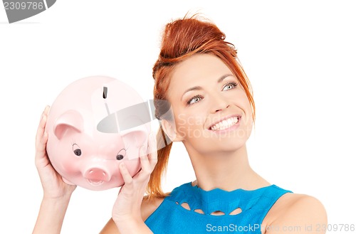 Image of lovely woman with piggy bank