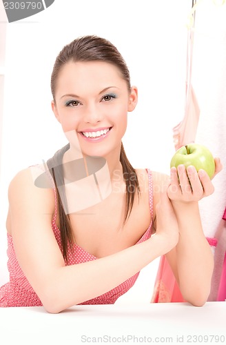 Image of young beautiful woman with green apple