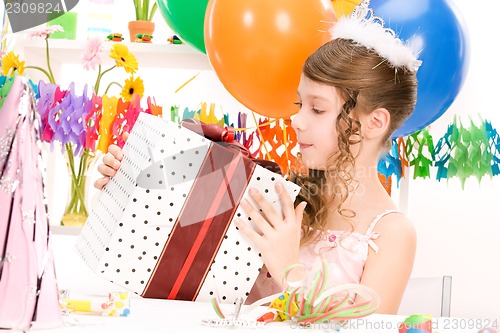 Image of party girl with balloons and gift box