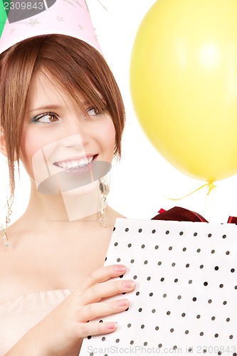Image of party girl with balloons and gift box