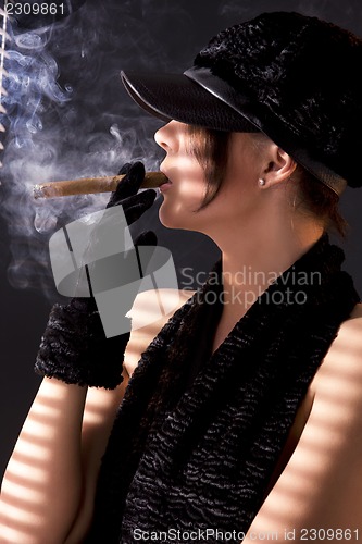 Image of woman in black astrakhan smoking cigar